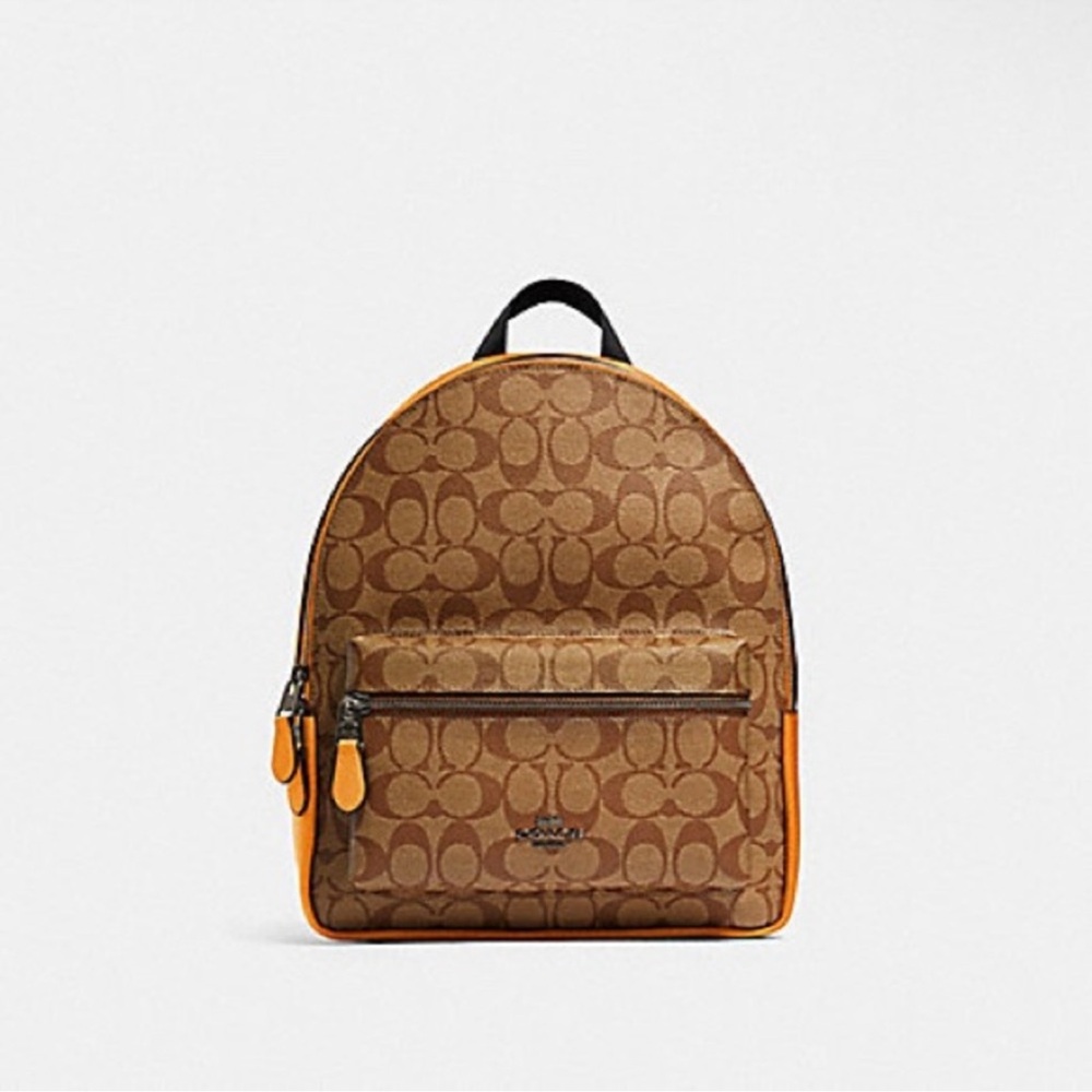 Coach Medium Charlie Backpack in Signature Canvas with orange leather details.